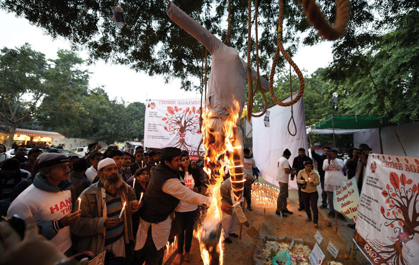 People burn an effigy during a memorial on the second death anniversary of the victim of December 16 gangrape, in New Delhi, Dec. 29. (Shahbaz Khan | PTI)