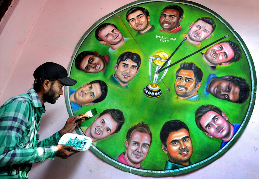 An Amritsar-based artist gives final touch to a painting, featuring all the fourteen captains of cricket world cup teams, in Amritsar, Feb. 11. (Press Trust of India)