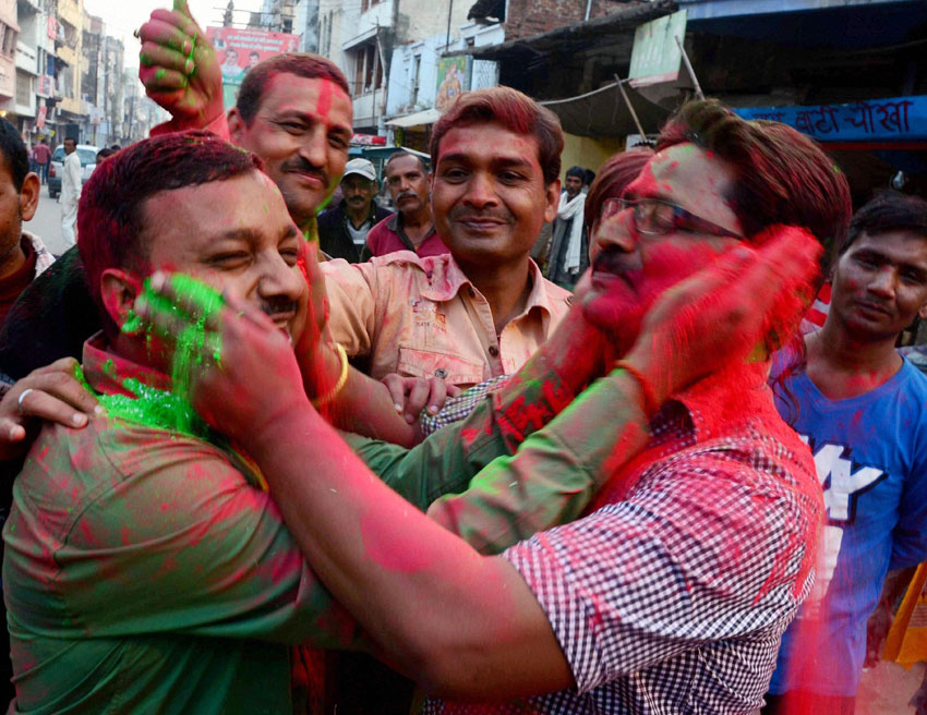 People celebrate team India's victory against Pakistan in ICC World Cup cricket match, in Allahabad, Feb. 15. (Press Trust of India)