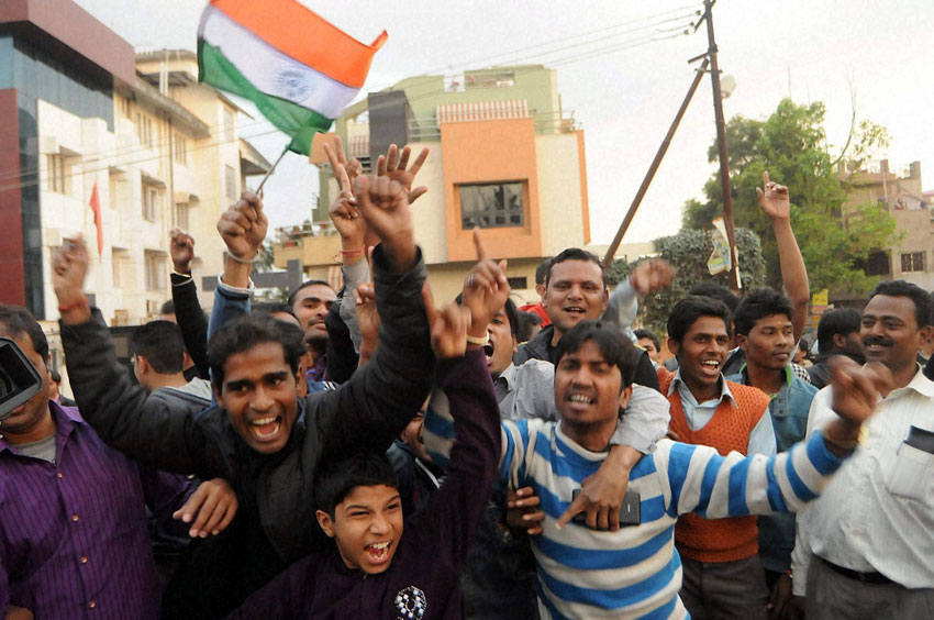 Cricket fans celebrate in front of Indian Skipper Mahendra Singh Dhoni's residence after team India's victory against Pakistan in ICC Cricket World Cup match, in Ranchi, Feb. 15. (Press Trust of India)