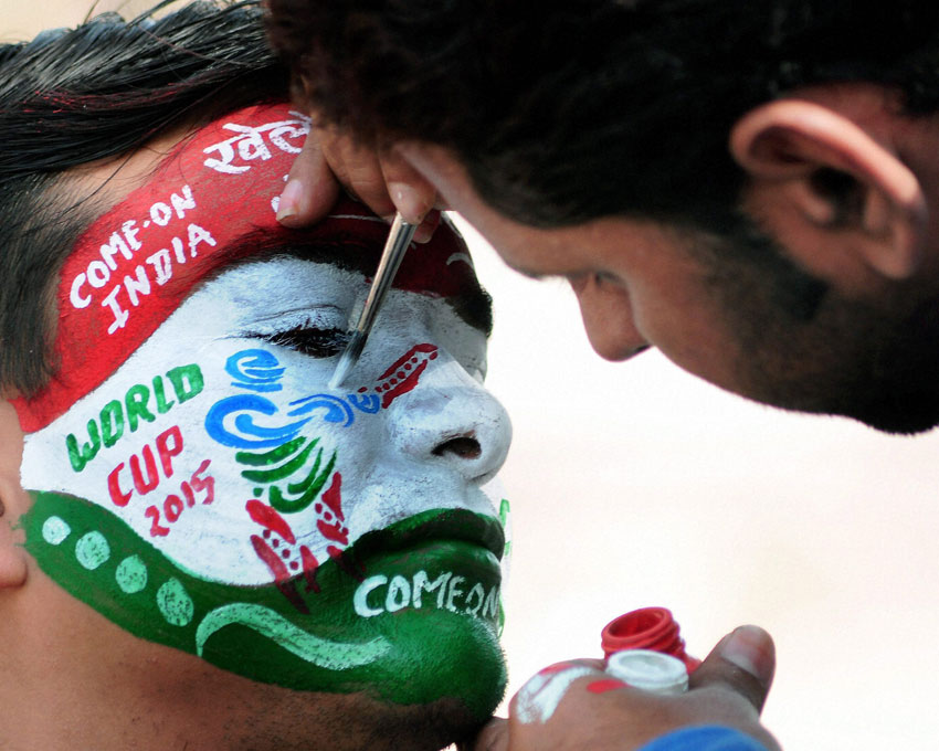 A cricket fan gets his face painted to wish good luck to team India for the ICC Cricket World Cup 2015 in Bikaner, Feb. 13. (Press Trust of India)