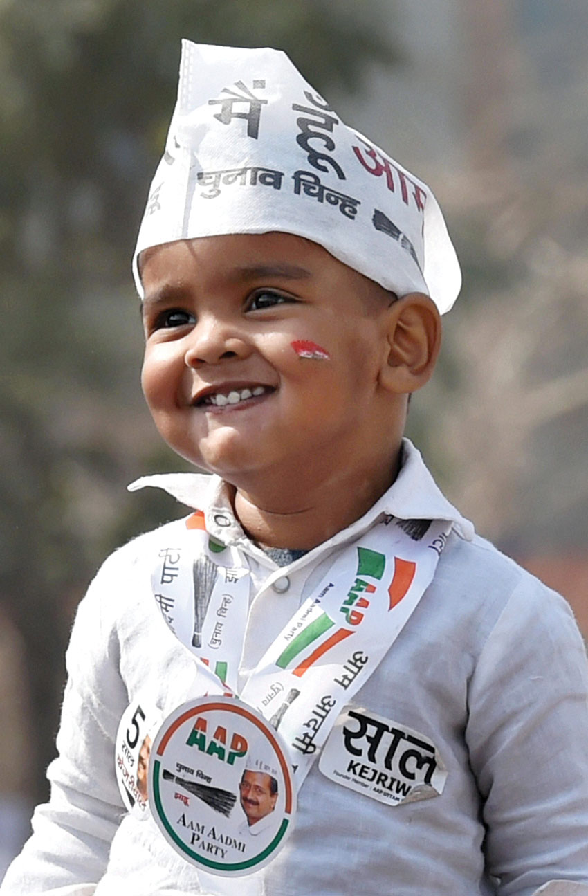 A child in an AAP supporter's get up during the oath ceremony of Delhi Chief Minister Arvind Kejriwal at Ramlila Maidan in New Delhi, Feb. 14. (Atul Yadav  | PTI)