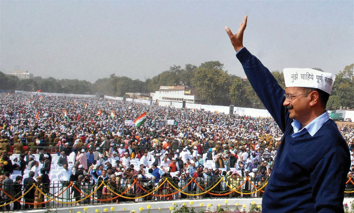 Delhi Chief Minister Arvind Kejriwal waves at supporters during the swearing-in ceremony at Ramlila Maidan in New Delhi, Feb. 14. (Press Trust of India)