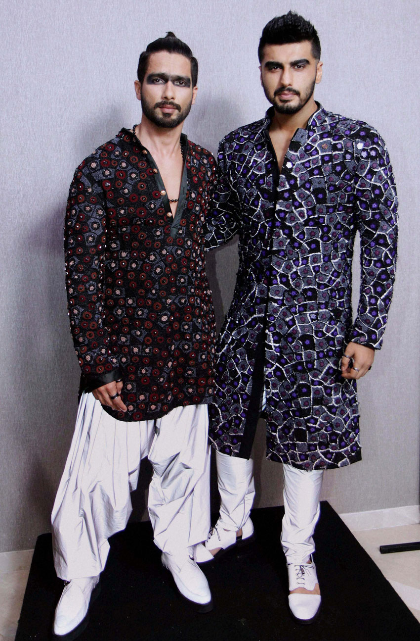 Bollywood actors Shahid Kapoor and Arjun Kapoor pose in an outfit by fashion designer Kunal Rawal, at the Lakme´ Fashion Week Summer Resort 2015, in Mumbai. (Press Trust of India)