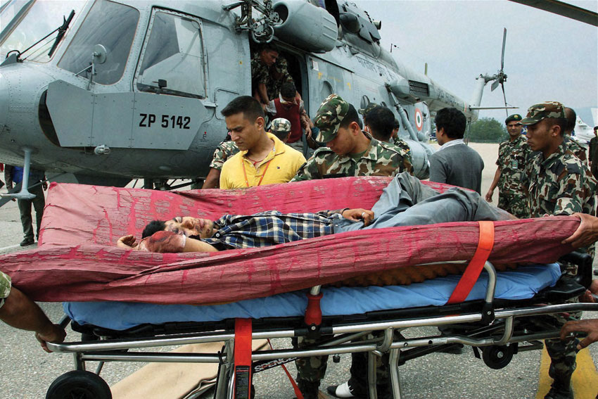 Army and IAF team shifting injured persons to safer places during their rescue operation for earthquake victims in Kathmandu, Apr. 27. (Press Trust of India)