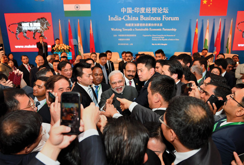 Prime Minister Narendra Modi shaking hands with business leaders at the India-China Business Forum in Shanghai, May 16. (Shahbaz Khan | PTI)