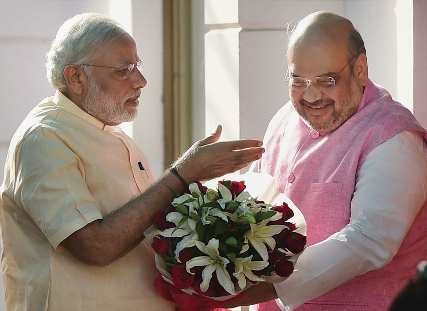 Prime Minister Narendra Modi being greeted by BJP president Amit Shah on his arrival at the party headquarters to meet the party's central office bearers on the first anniversary of his government, in New Delhi, May 26. (Manvender Vashist | PTI)