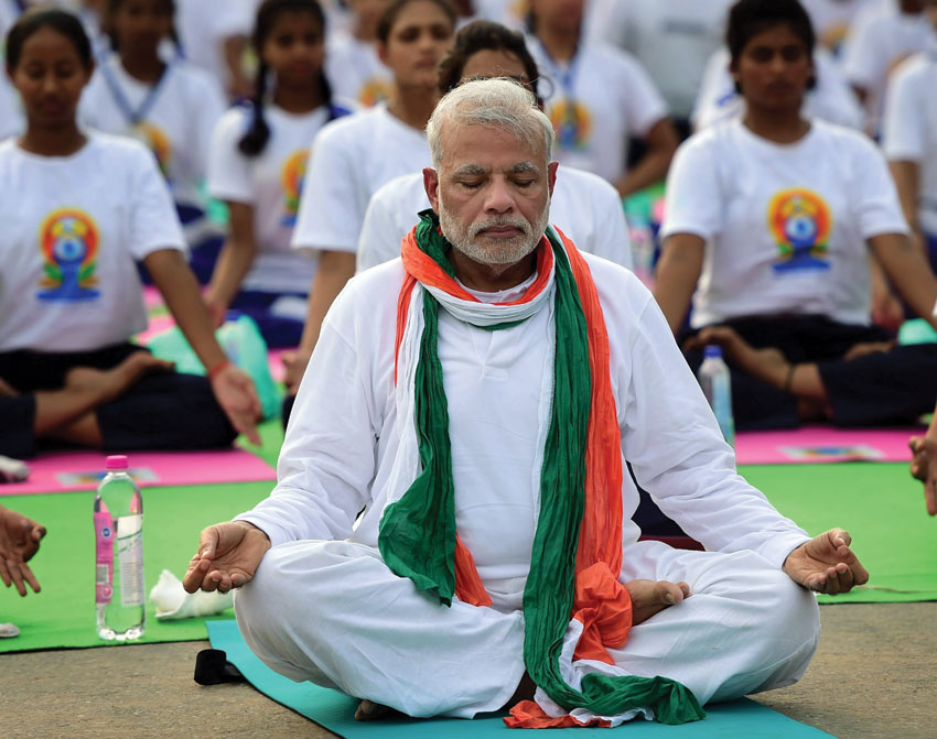 Prime Minister Narendra Modi (front) performs yoga along with thousands of others at a mass yoga session to mark the International Day of Yoga 2015 at Rajpath in New Delhi, June 21. (Manvender Vashist | PTI) 