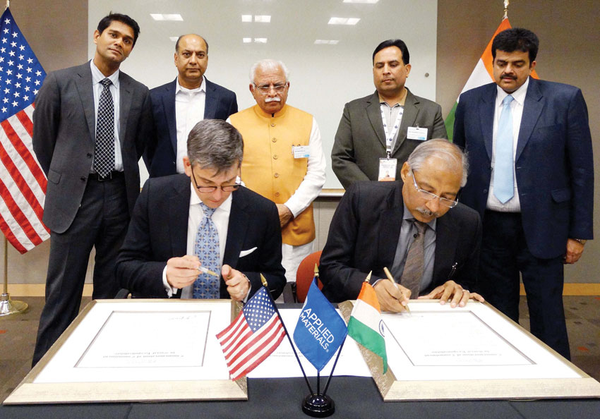 Haryana Principal Secretary Industries Devender Singh and a representative of Applied Material signing a MoU in the presence of Chief Minister Manohar Lal Khattar and Industries Minister Capt. Abhimanyu in San Francisco, Aug. 21. (Press Trust of India) 