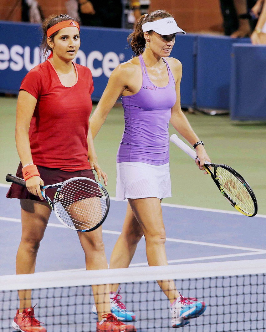 Sania Mirza and partner Martina Hingis after winning the doubles semifinal match against the Italian pair of Sara Errani and Flavia Pennetta at the U.S. Open at Flushing Meadows in New York, Sept. 9. (Press Trust of India) 