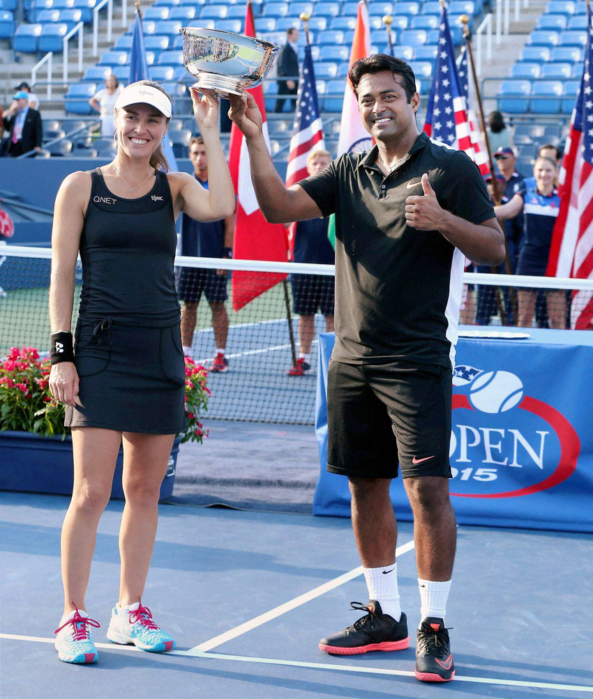 Leander Paes and Martina Hingis pose with the trophy after winning the mixed doubles final match against B Mattek-Sands and Sam Querrey at U.S. Open in New York, Sept. 11. (Press Trust of India) 