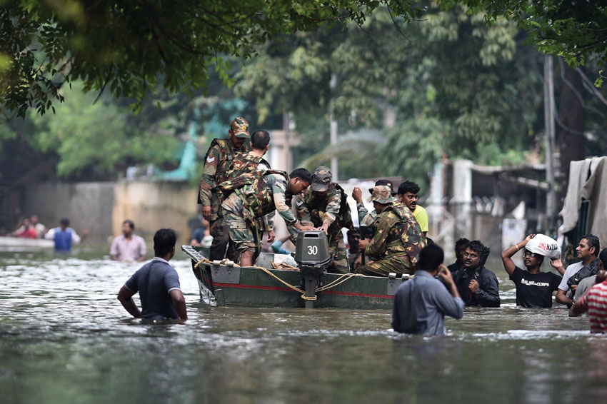 Army personnel rescuing people from a flooded locality in Chennai after heavy rainfall, Dec. 3. (Press Trust of India)