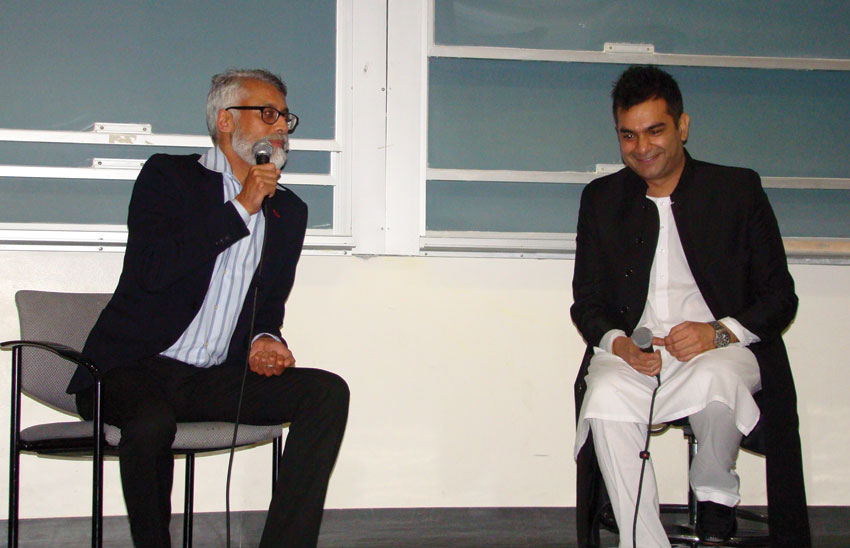 Professor Harsha Ram (l) chats with Sarmad Sultan Khoosat.
