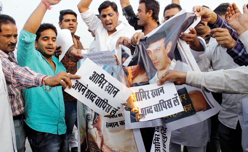 Youth display posters during a protest against actor #AamirKhan following his remarks over growing intolerance in the country in Jaipur, Nov. 26. (Press Trust of India)