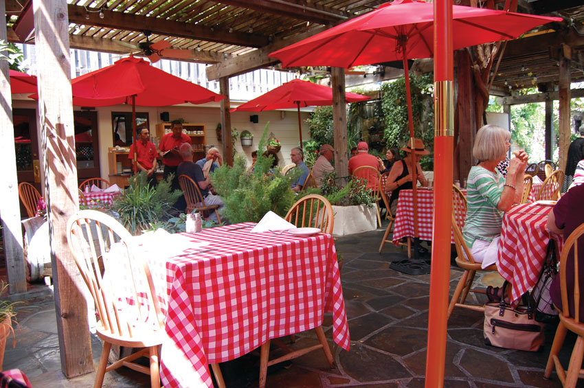 The Swiss Hotel's outdoors dining is Old Italy under a lattice dripping with vivid colorful flora. (Al Auger)