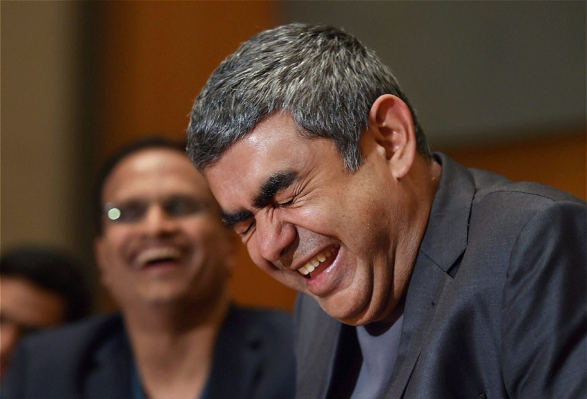 Infosys Technologies CEO Vishal Sikka laughs during a press conference to announce the 3rd quarter results of the company at its headquarters in Bengaluru, Jan. 14. (Shailendra Bhojak | PTI) 