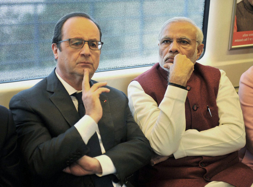 Prime Minister Narendra Modi and French President Francois Hollande travel by Metro train to Gurgaon for inauguration of the headquarters of the 102-nation International Solar Alliance, Jan. 25. (Press Trust of India) 