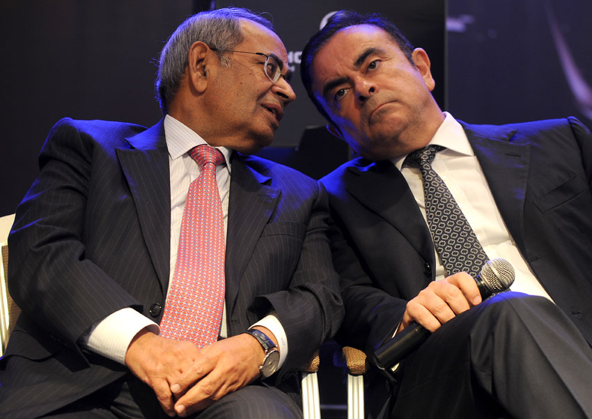 File photo of co-chairman of Hinduja Group, G.P. Hinduja, and CEO and chairman of Renault-Nissan, Carlos Ghosn (r) as they share a point during the launch of Hinduja Group's flagship brand, Ashok Leyland's multi-purpose vehicle 'STILE,' in Chennai, July 16, 2013. (Manjunath Kiran | AFP | Getty Images) 