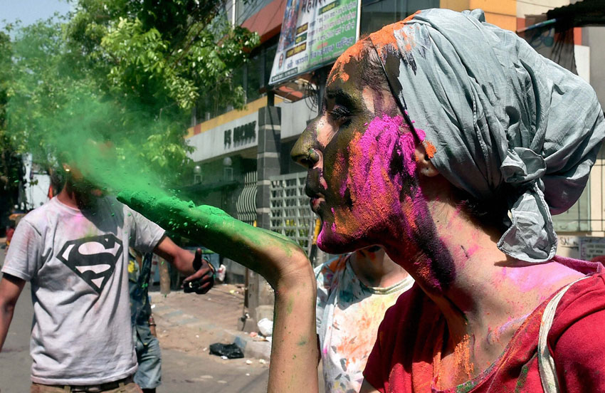 A foreign tourist sprays color while celebrating ‘Holi’ in Kolkata, Mar. 23. (Swapan Mahapatra | PTI) 