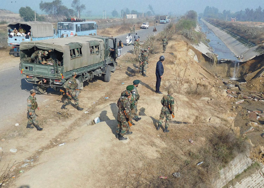 Army personnel standing near a canal that was damaged by the Jat people during their agitation for reservation, at Rohat village in Sonepat, Feb. 23. (Press Trust of India) 