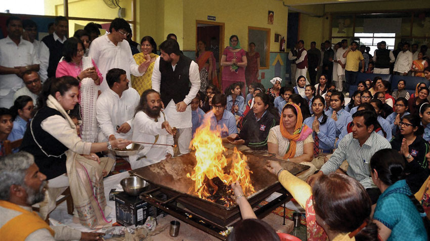 Spiritual leader Sri Sri Ravi Shankar performs a hawan along with the staff and students of a school that was torched during the Jat agitation, in Rohtak, Haryana, Feb. 27. (Press Trust of India) 