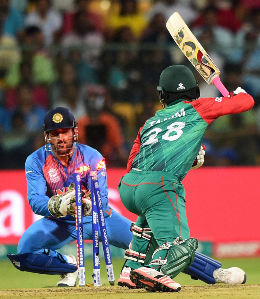 Bangladesh Tamim Iqbal stumped by Indian skipper and wicketkeeper M.S. Dhoni during the ICC World T20 match between India and Bangladesh at Chinnaswamy Stadium in Bengaluru, Mar. 23. (Shailendra Bhojak | PTI) 