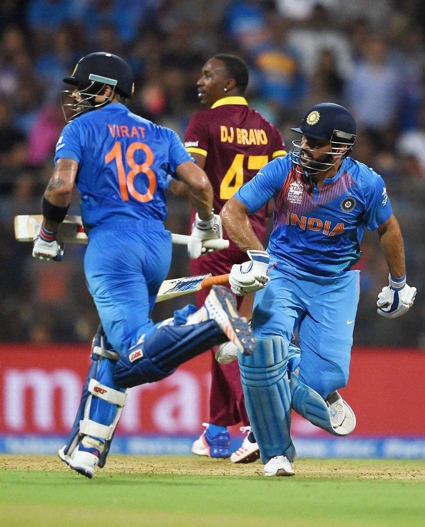 India’s Virat Kohli and skipper M.S. Dhoni in action during the ICC WT20 Semi Final match against West Indies at Wankhede Stadium in Mumbai, Mar. 31. (Mitesh Bhuvad | PTI) 