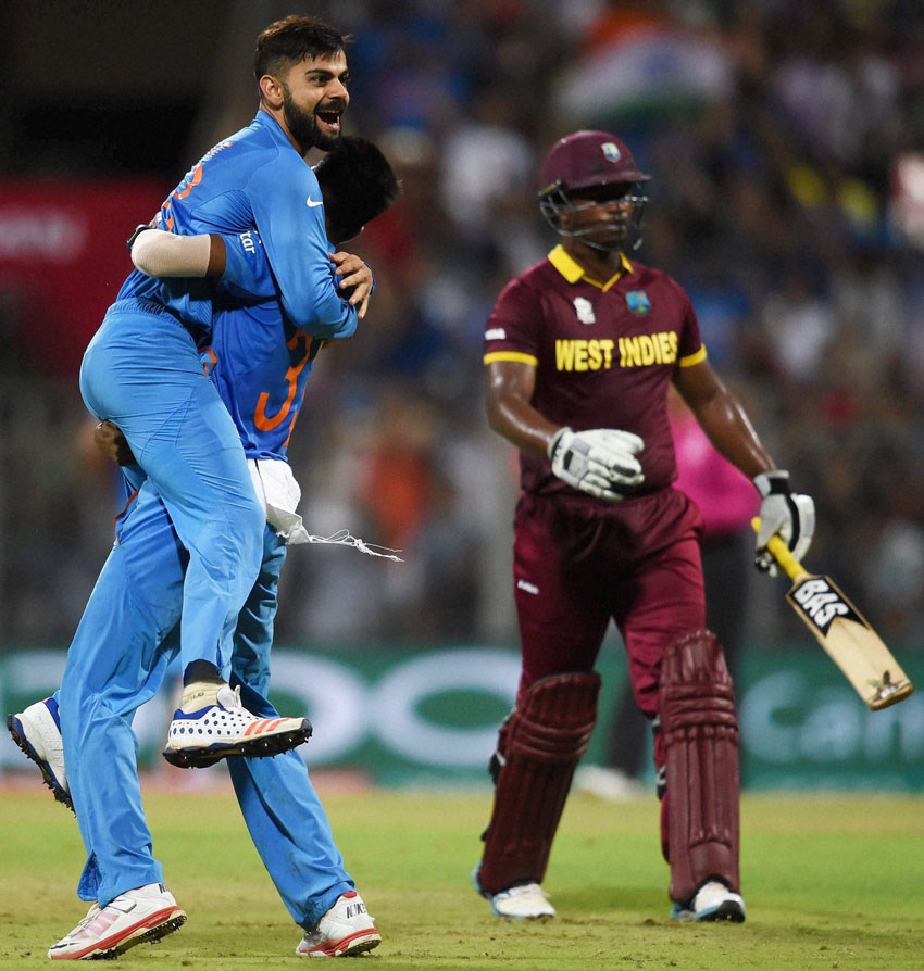 Indian player Virat Kohli celebrates the wicket of Johnson Charles during a ICC WT20 match against West Indies at Wankhede Stadium in Mumbai, Mar. 31. (Mitesh Bhuvad | PTI) 