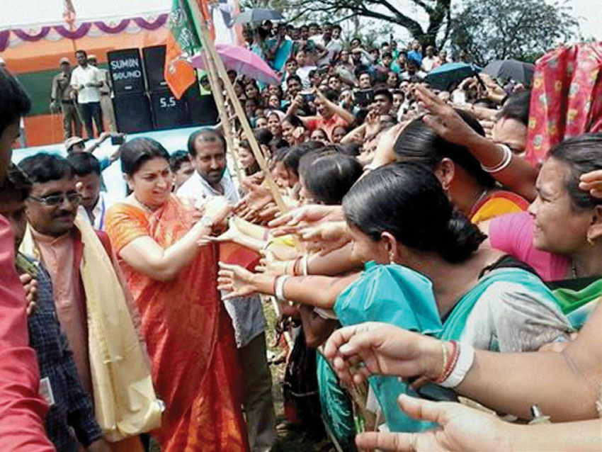Minister for Human Resource Development, Smriti Irani meeting the crowd at an election campaign rally in support of BJP candidates in Karimganj, Assam, Mar. 30. (Press Trust of India) 
