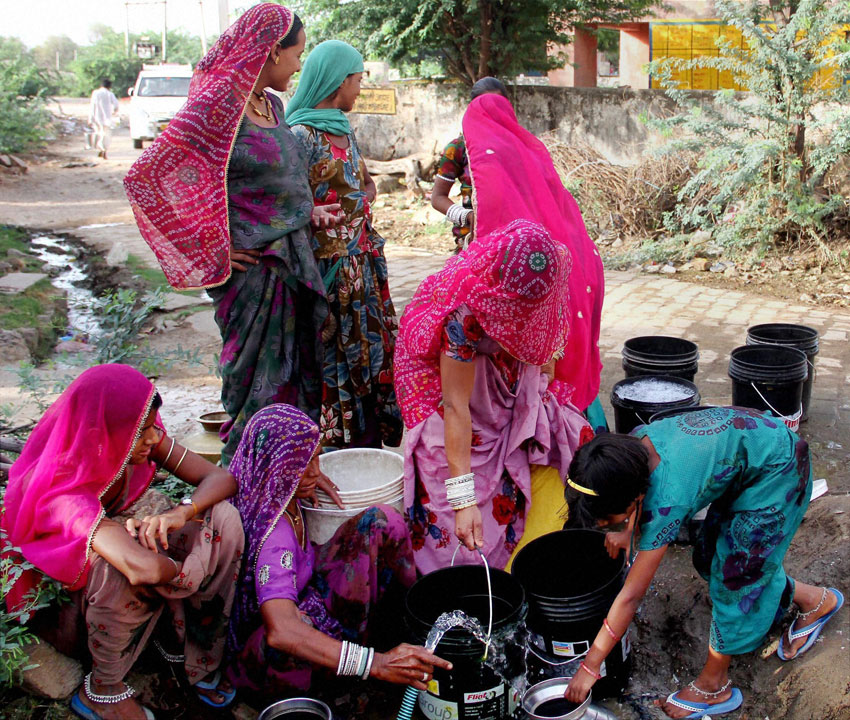 People collect water from a roadside pipeline on the outskirts of Ajmer in Rajasthan, April 26. (Press Trust of India) 
