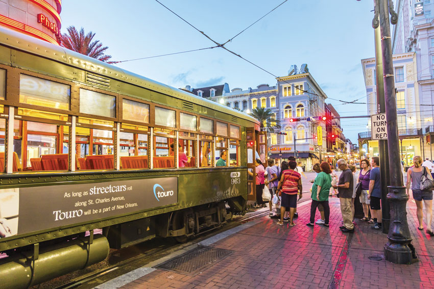 A trolley rolls along St. Charles Avenue in New Orleans. 