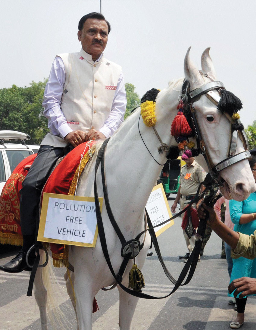 BJP MP Ram Prasad Sharma rides a horse on his way to attend Parliament session in New Delhi, April 27, marking a protest against the odd-even scheme implemented by the AAP-led government in Delhi. (Press Trust of India) 