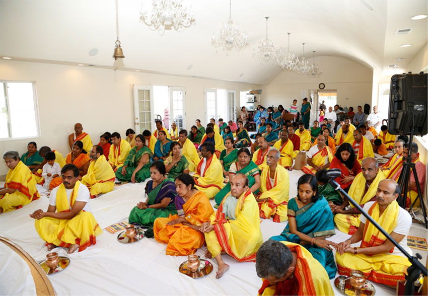 Devotees sitting down for “kalash puja” in Balaji Temple Ananda Hall
