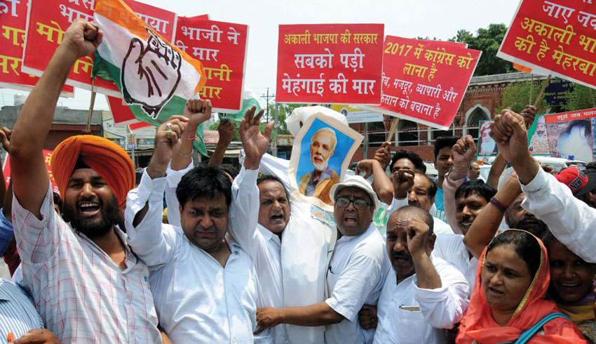 Congress leaders and workers protest against Centers' BJP government and its alliance partner in Punjab SAD (B) against rampant corruption, drug abuse etc. at Amritsar, June 27. (Press Trust of India)