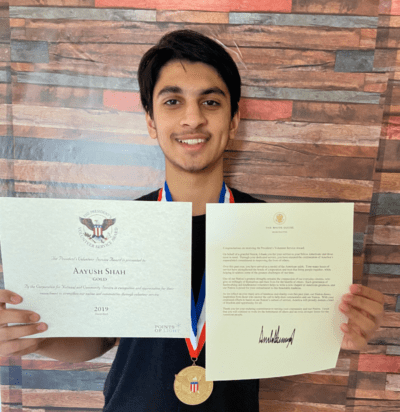 Aayush Shah holding his U.S. Presidential Award for Volunteering (Aayush Shah)