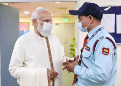 (Above): Indian Prime Minister Narendra Modi visits the vaccination center at Dr. Ram Manohar Lohia Hospital in New Delhi, Oct. 21, 2021, as India achieves 100 crore vaccination mark. (PIB)